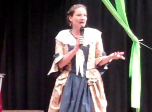 Operetta! A World Tour: Singer in 18th Century costume with microphone.